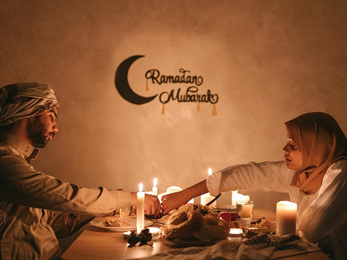 An image of a couple having a predawn meal in Ramadan.