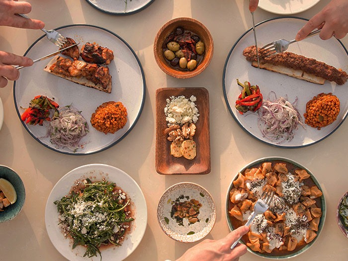 Bird's eye view of a table set with dishes of Middle Eastern cuisine.