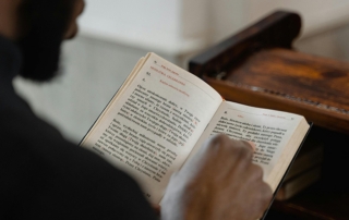 Person reading a Holy Bible