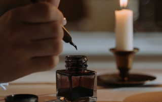 Hand holding a quill