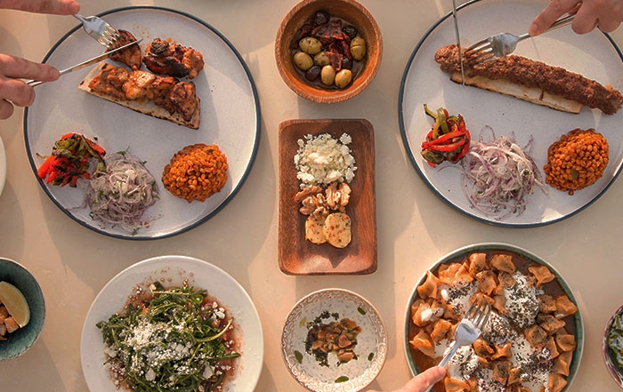Bird's eye view of a table set with dishes of Middle Eastern cuisine.